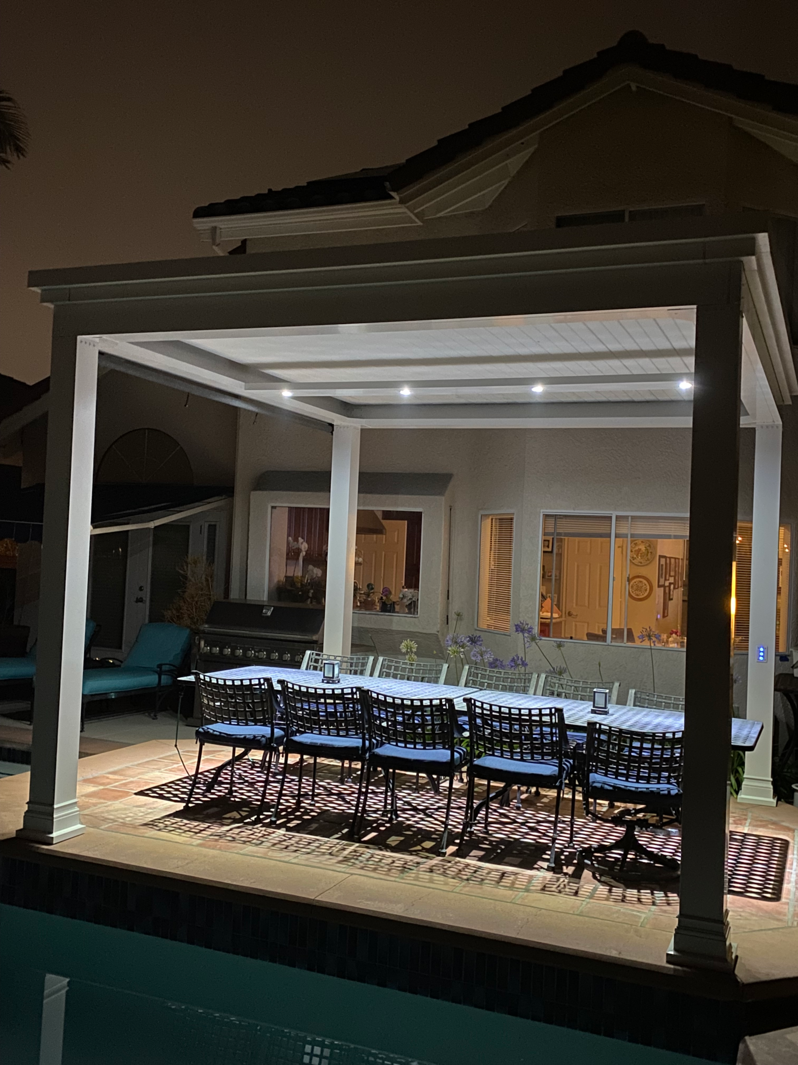 puck lights in outdoor space pergola