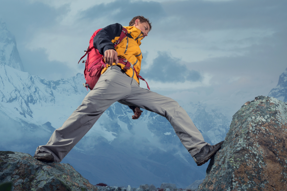 a man on hiking pants at the trailhead, highlighting ease of movement while on hike.