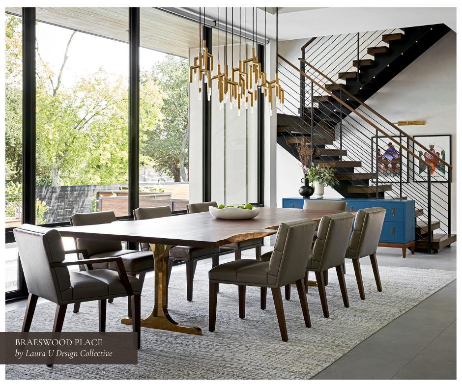 Modern dining room anchored by a live-edge wood table with a sculptural brass base, taupe leather chairs, brass chandelier, and bold blue console, with floor-to-ceiling windows overlooking a serene backyard.
