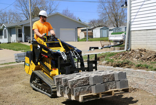 skid steer operator in the field 