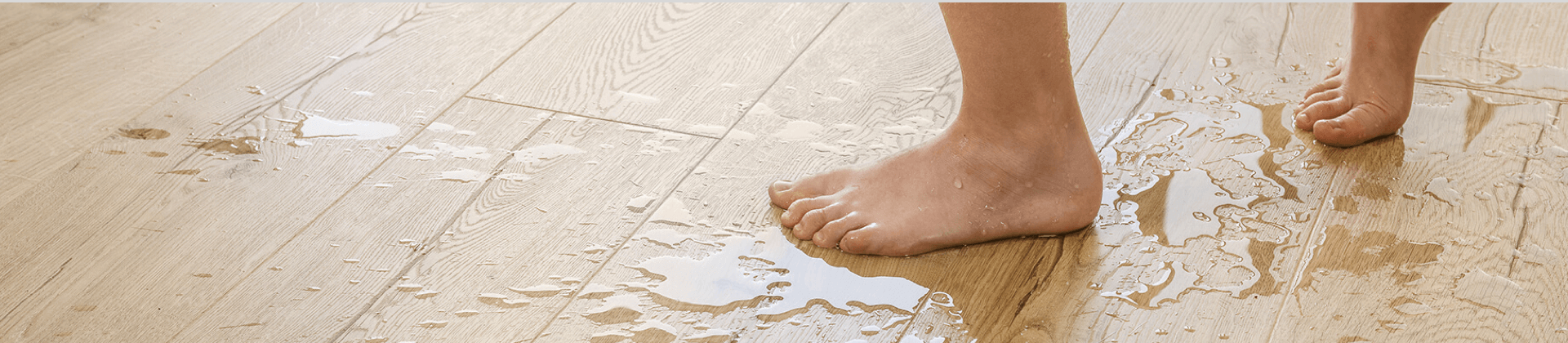 A close-up of a laminate floor with water-resistant finish. 