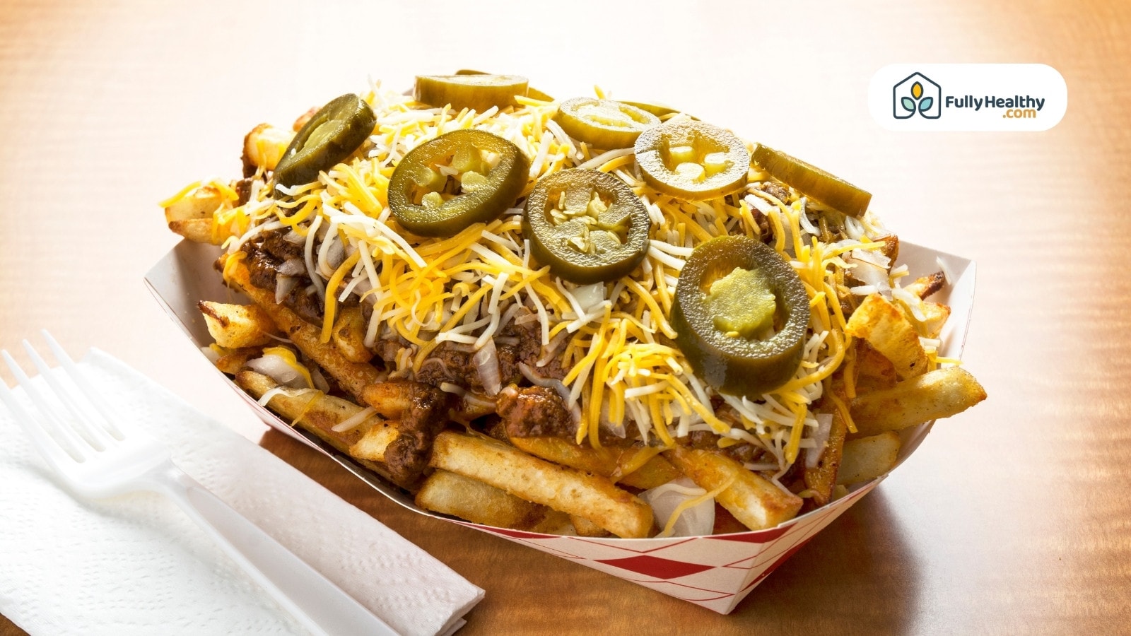 Loaded fries topped with cheese and jalapeño slices