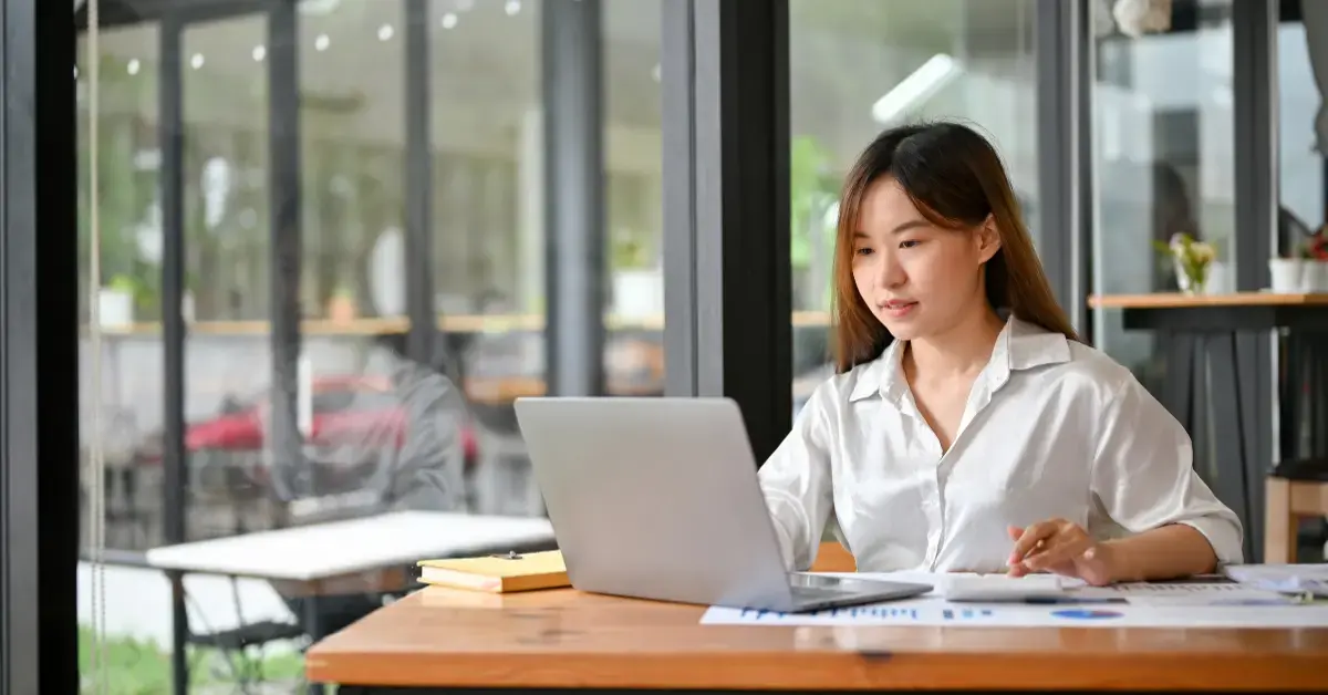 Woman reviewing a substitute for return IRS notice with Form 1040, creator income records, and business expense documents.