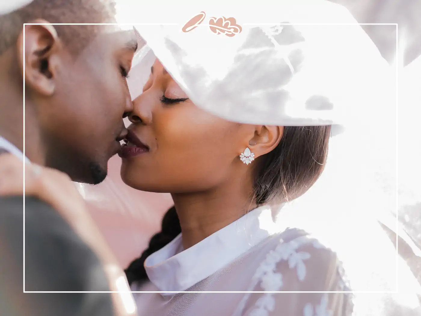 Romantic moment of a bride and groom about to kiss, with a veil softly draping over them. Fabulous Flowers & Gifts