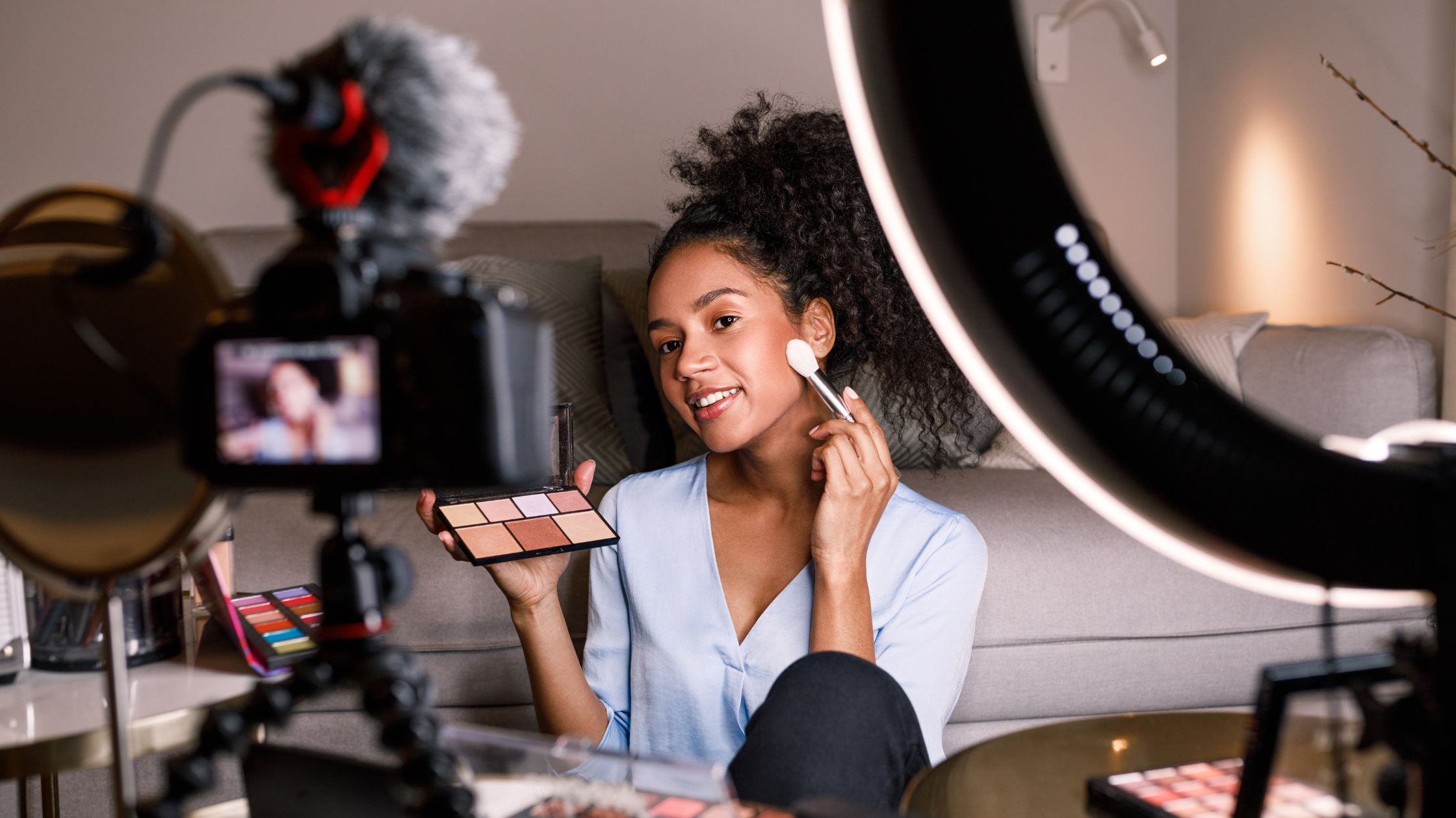 Influencer filming live stream shopping content with makeup products