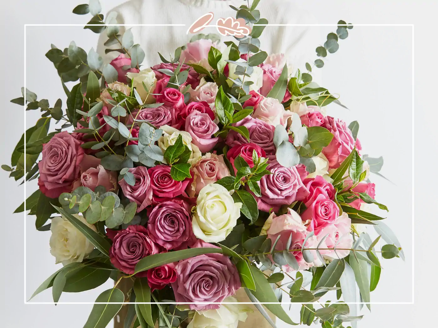 A stunning bouquet of pink, white, and red roses, beautifully arranged with lush green foliage. Fabulous Flowers and Gifts.