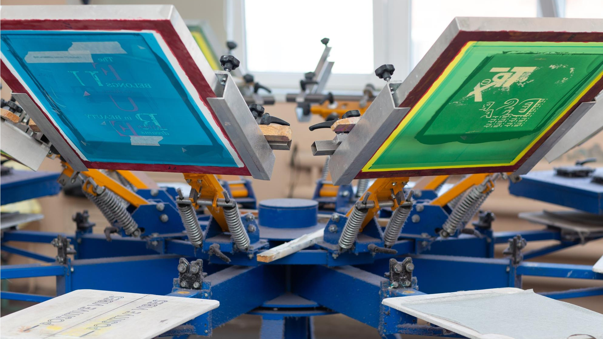 A rotary silk screen printer ready to print