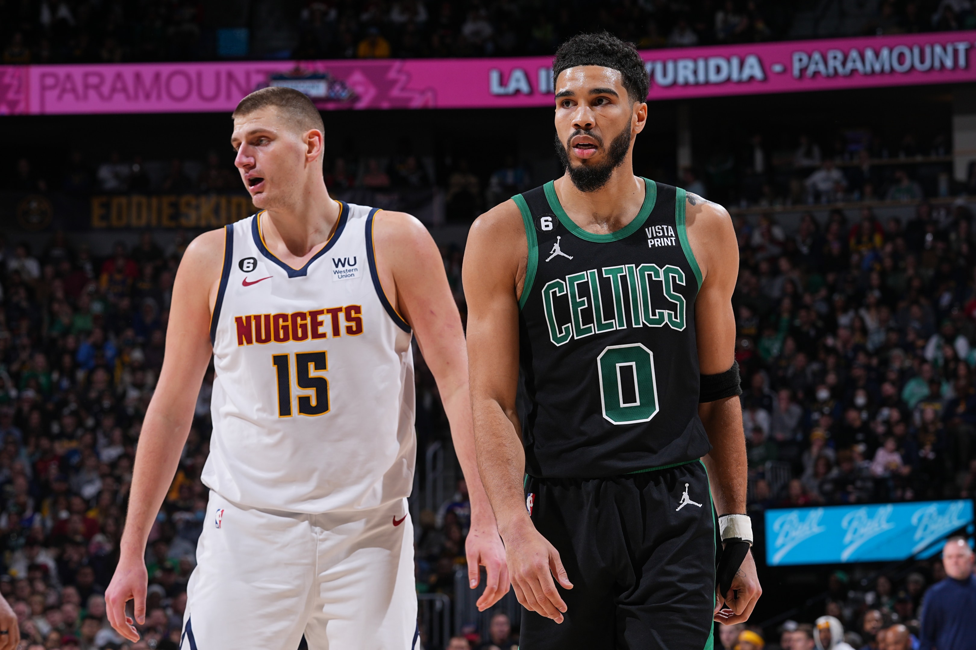 Nikola Jokic of the Denver Nuggets and Jayson Tatum of the Boston Celtics stand on the court during a game in Denver, Colorado. 