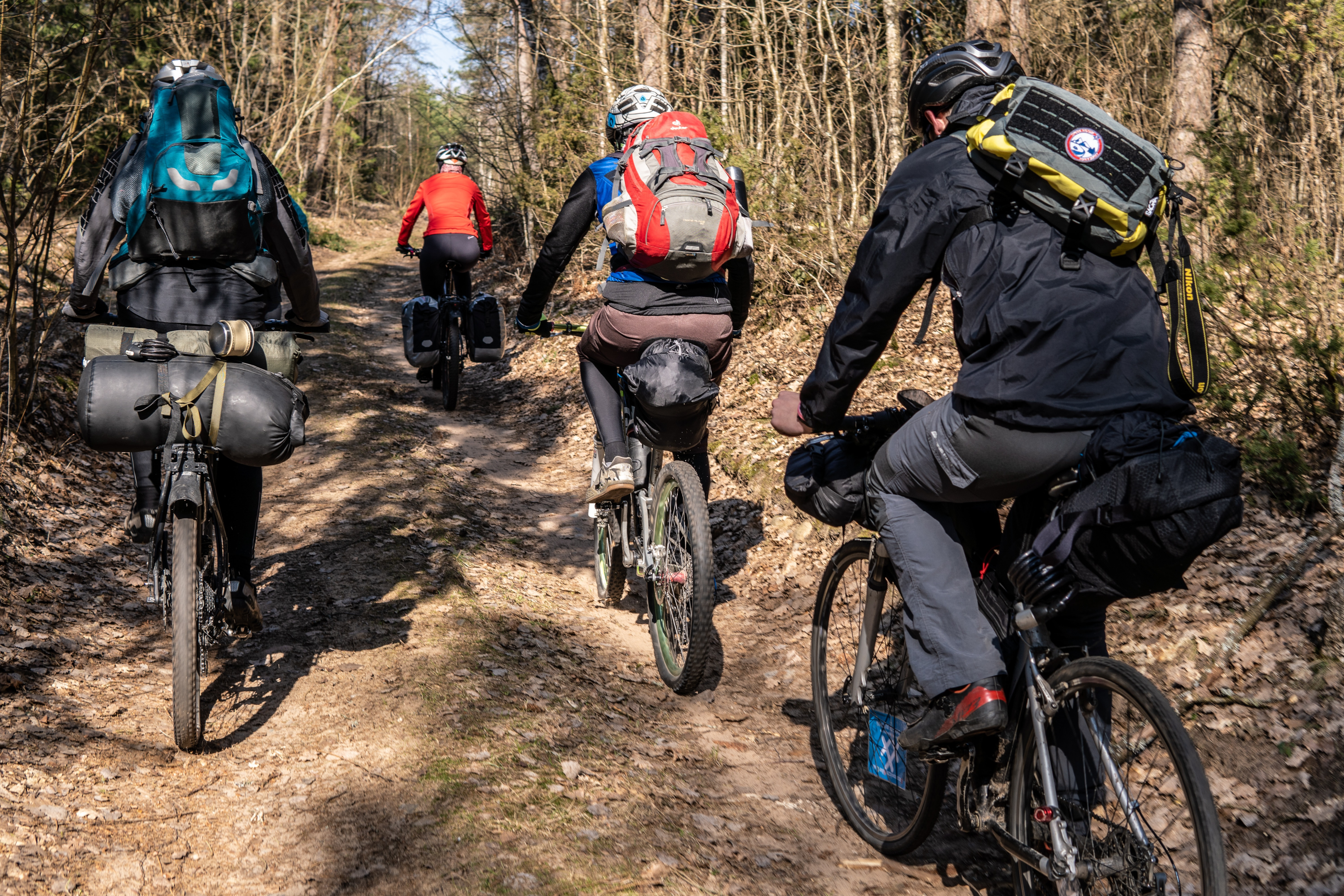 People biking on a dirt road