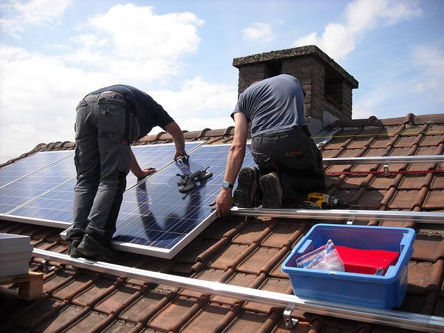 Solar installers installing a new solar system for significant cost savings.