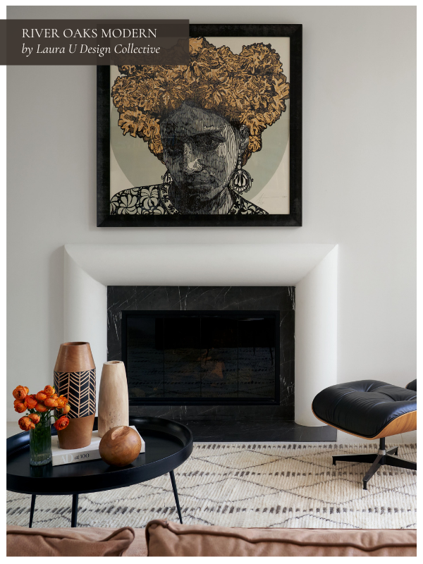a puffy white fireplace surround with bold art and an Eames lounge chair in the corner