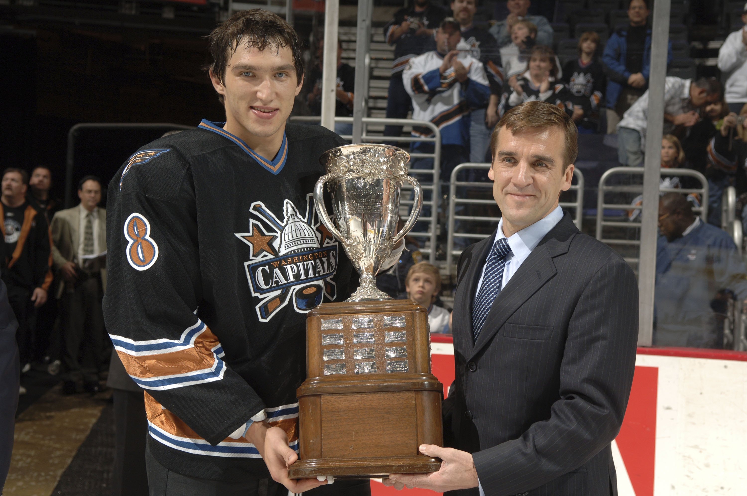 Washington Capitals' Alexander Ovechkin receives the Calder Trophy from VP and General Manager of the Washington Capitals, George McPhee, before a hockey game against the Atlanta Thrashers in 2006.