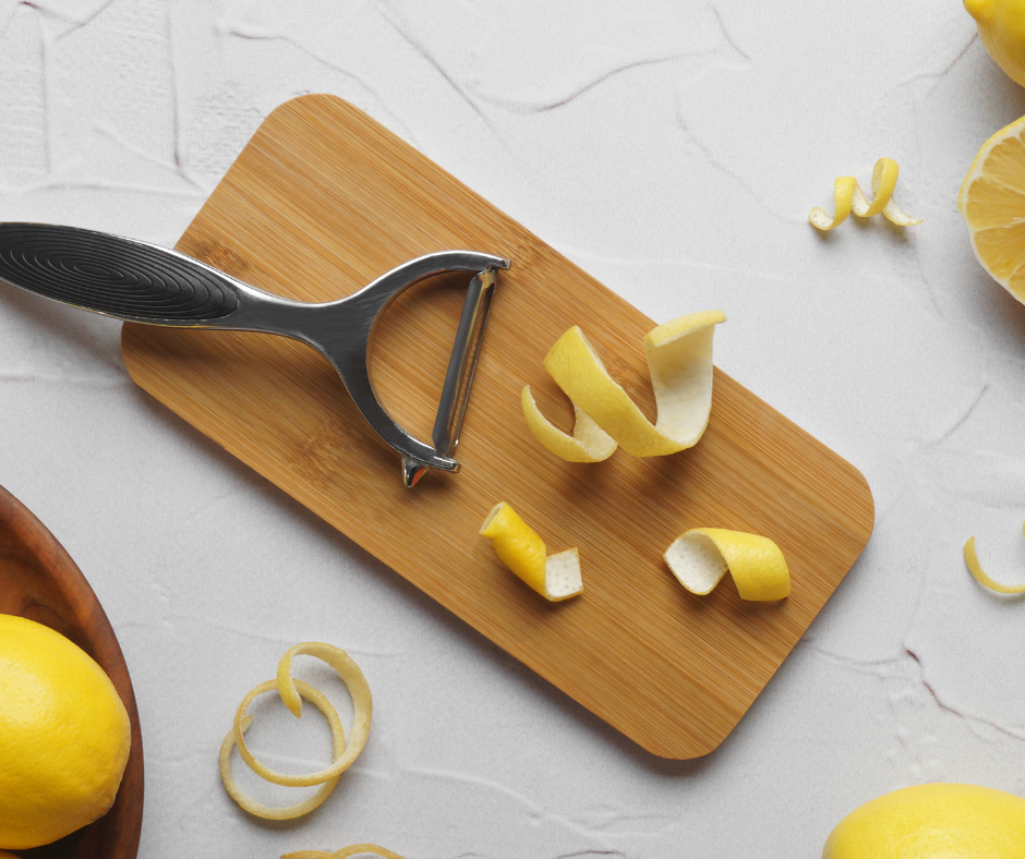 vegetable peeler, lemon peels, and a cutting board