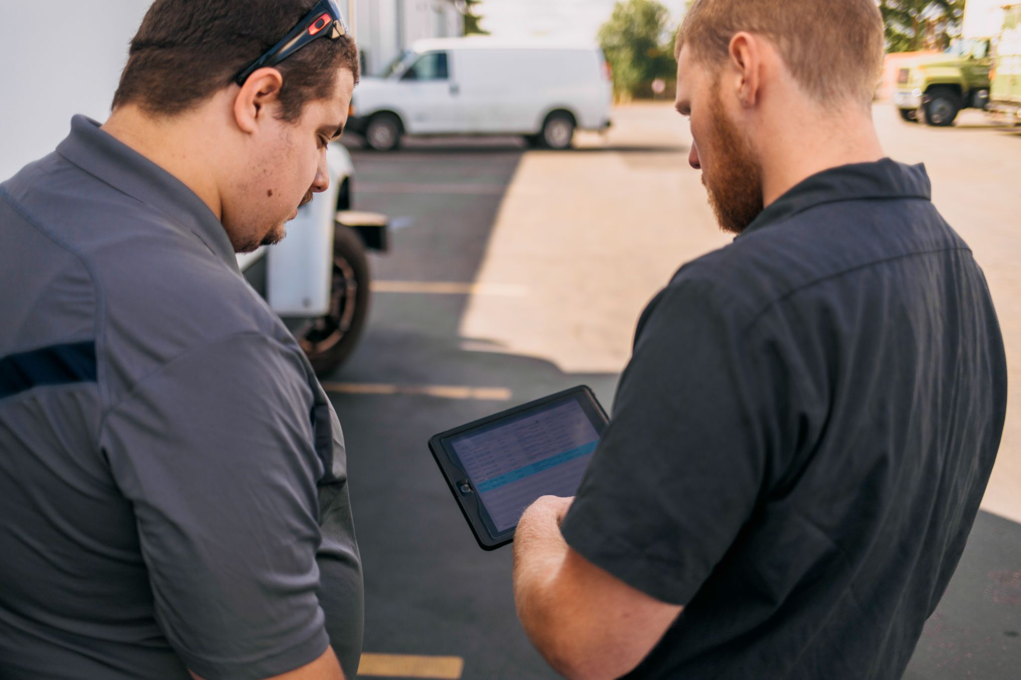 Two people looking at a tablet together