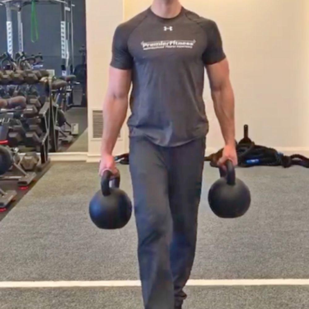 A person doing Farmer's Walks to improve their grip strength