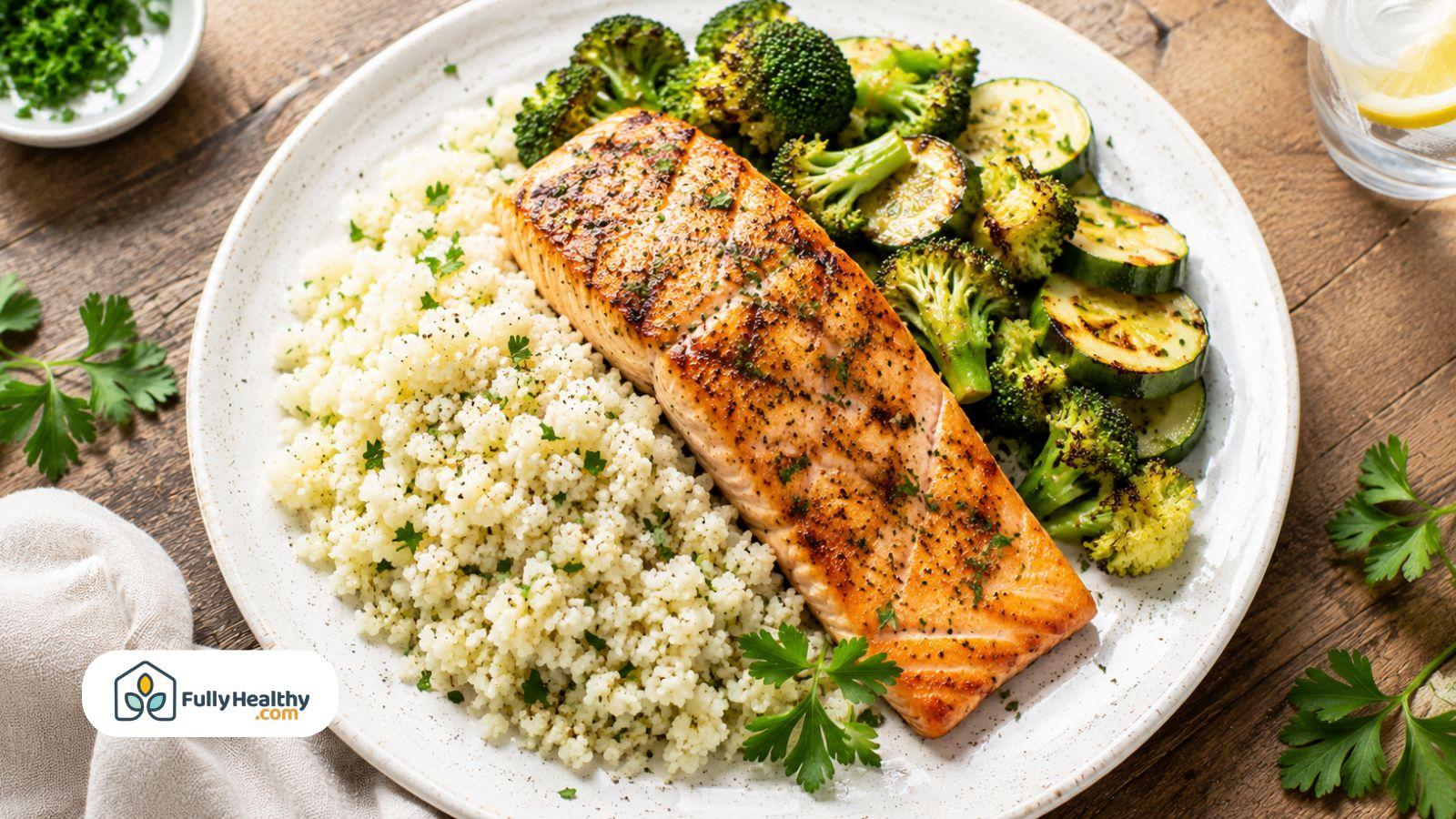 Grilled salmon served with cauliflower rice and roasted broccoli for a keto meal.