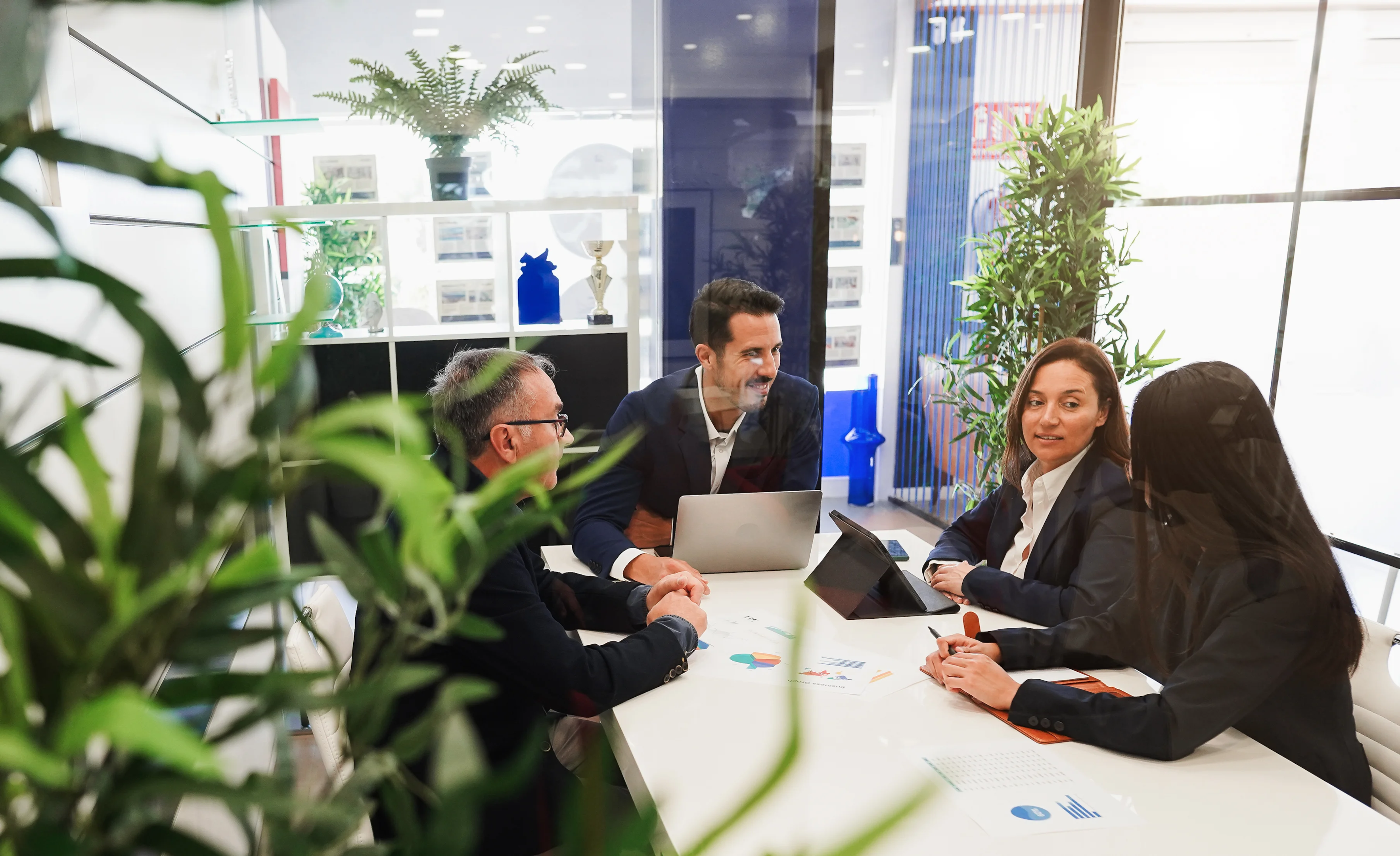 An image showing a team of professionals discussing real estate office management policies for effective implementation.