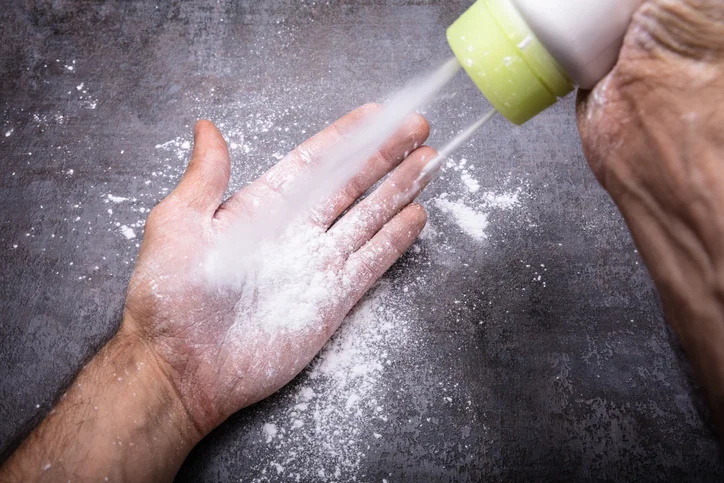 A person using a baby powder