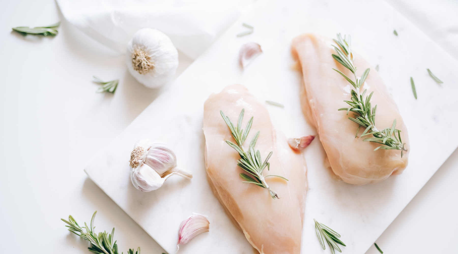 boneless skinless chicken breast on a cutting board