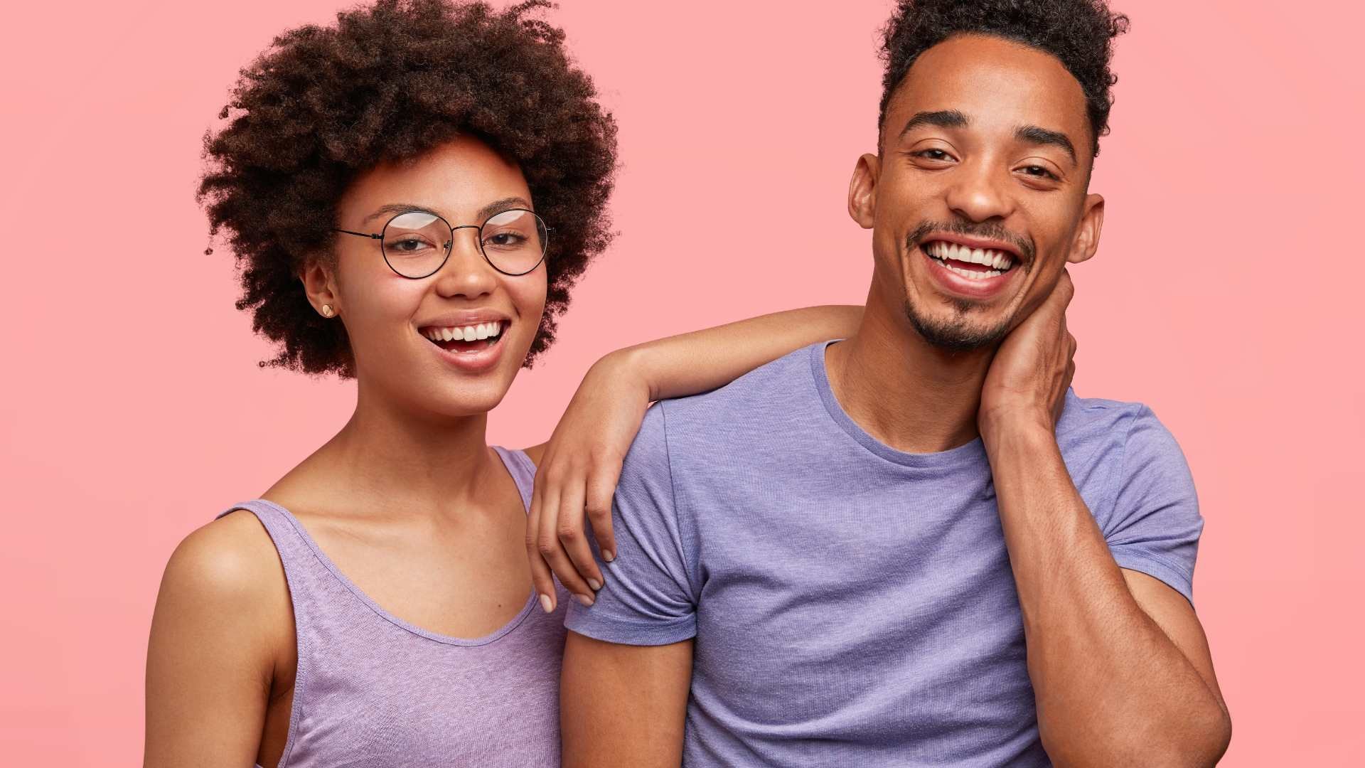 Top 10 Probiotics in South Africa - The Good Stuff showing a stylish couple in pastel outfits, laughing together with a pink background.