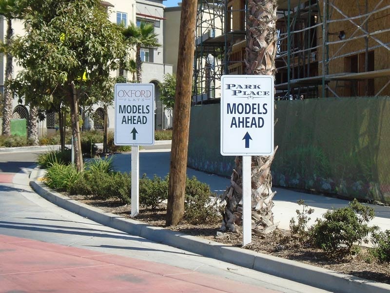 Directional signs for Oxford Flats and Park Place guide visitors to model homes, helping create a smooth and welcoming experience throughout the community.