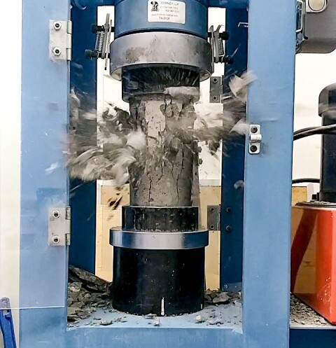 An image of a cylinder test of concrete being performed on field-cured cylinders