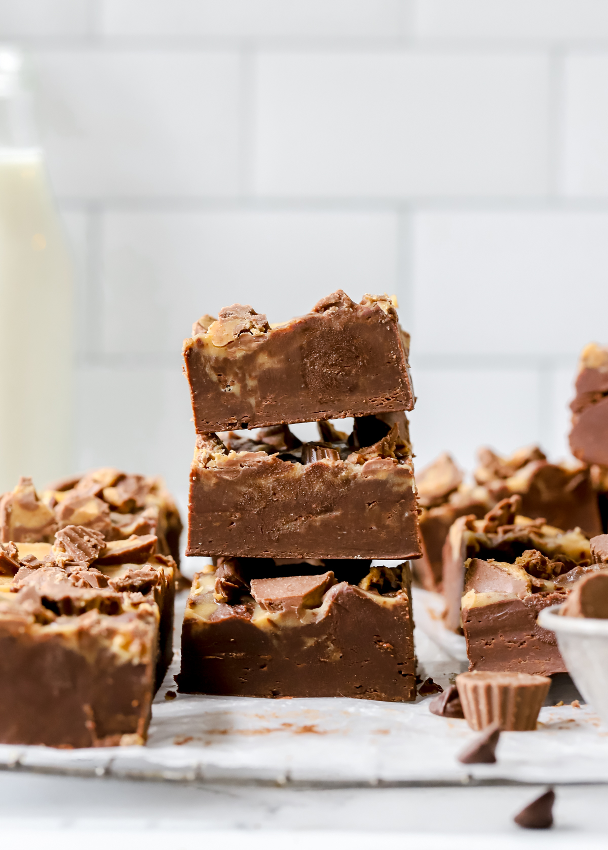 three chocolate peanut butter fudge squares stacked on top of each other