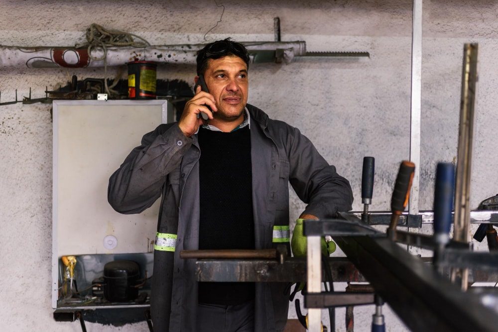 A man using mobile phone in a hybrid environment for a unique business.