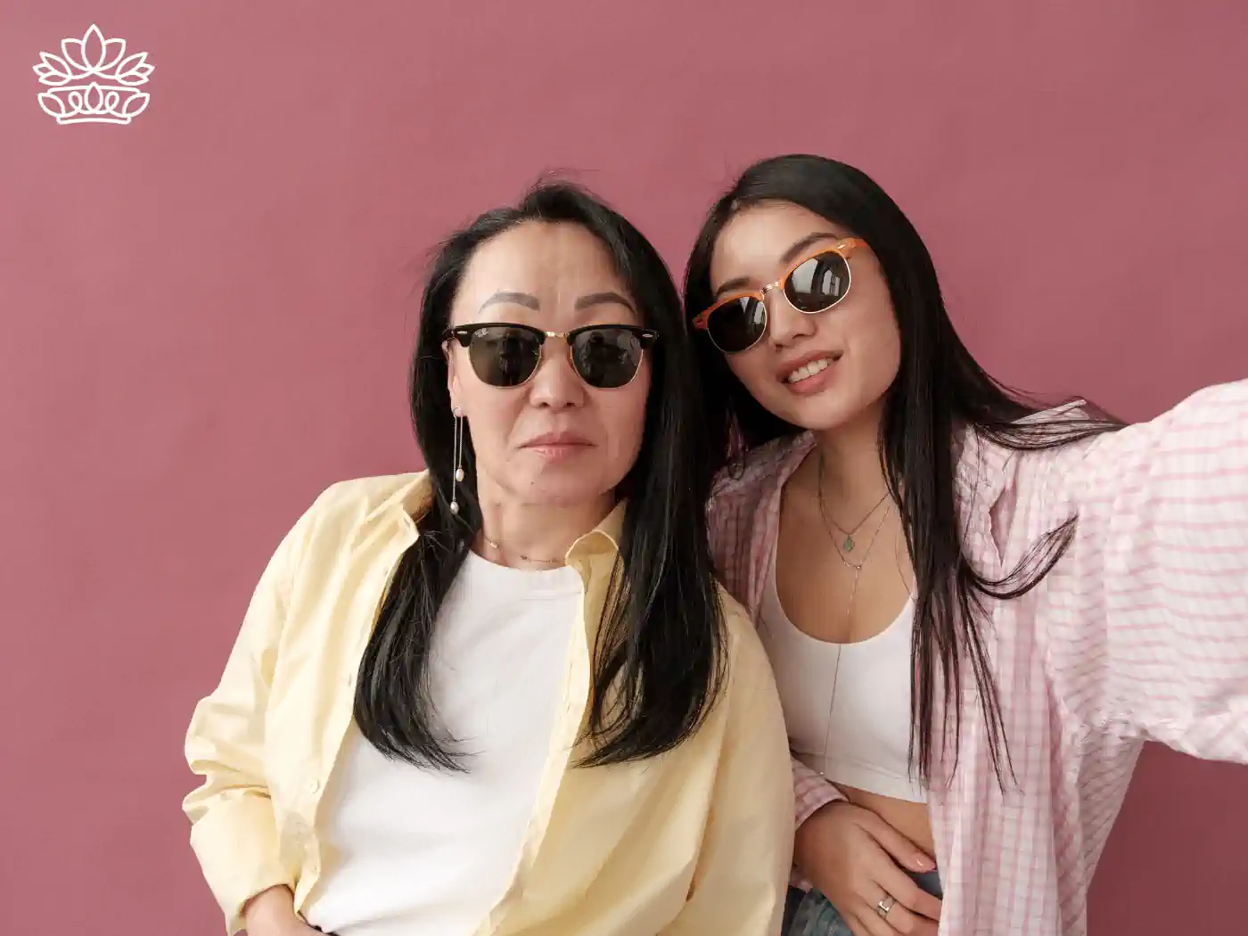 Mother and daughter posing together in sunglasses, sharing a stylish moment, reflecting their unique bond. Gift boxes for mum. Delivered with heart. Fabulous Flowers and Gifts.