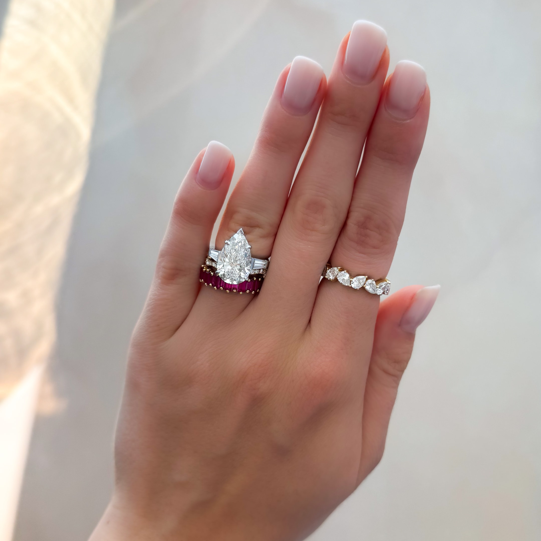 translunar with tapered baguettes and a pear cut diamond