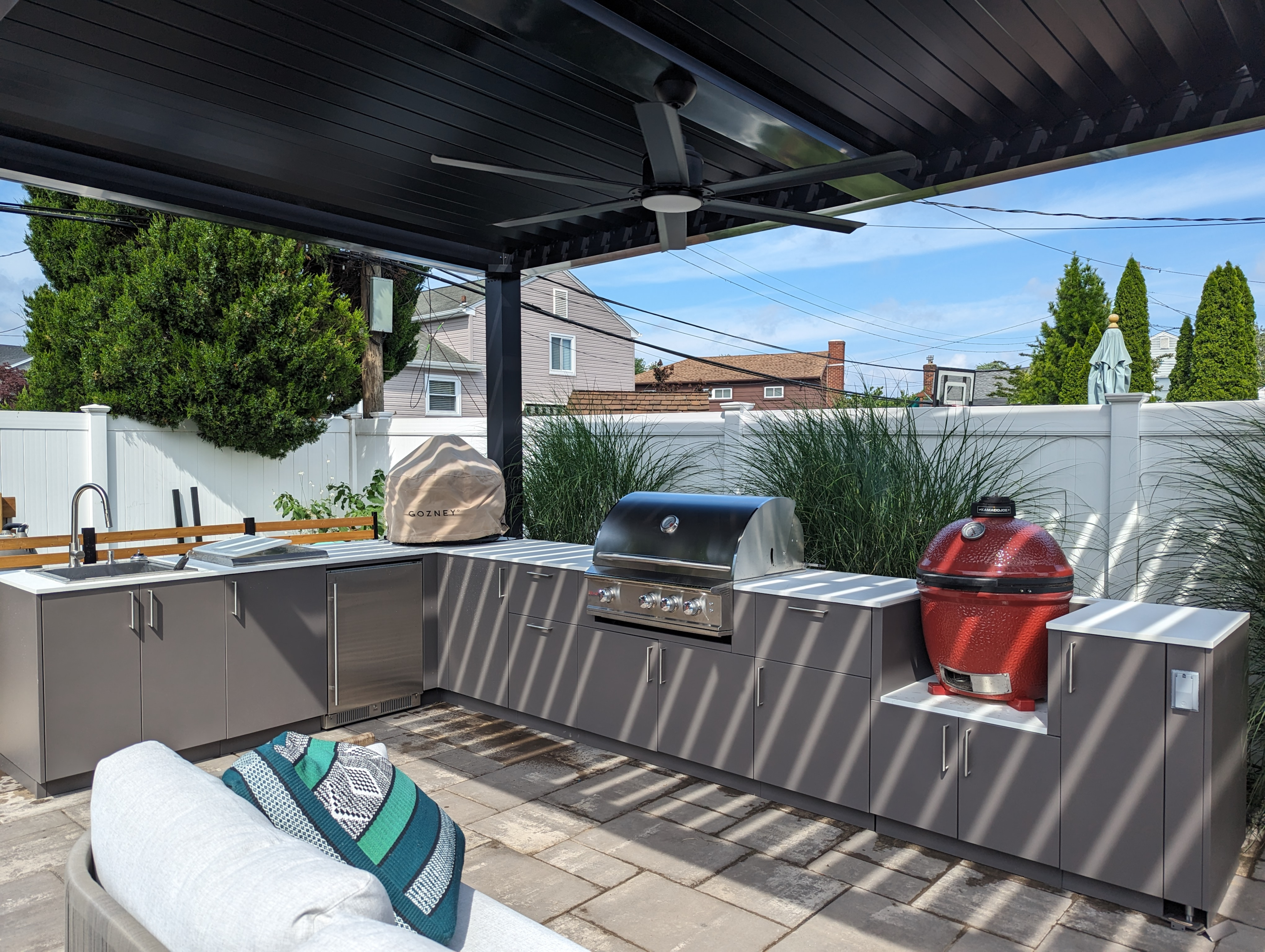 Outdoor Kitchen room with pergola create shade from the summer sun with grill on patio