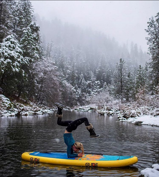 sup yoga on a paddle board in winter