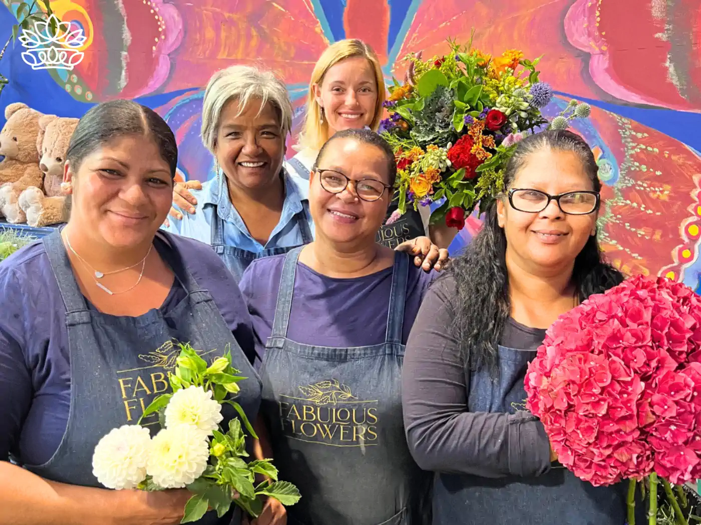 A cheerful group of florists holding bouquets, part of the "Jubilee" collection by Fabulous Flowers and Gifts.