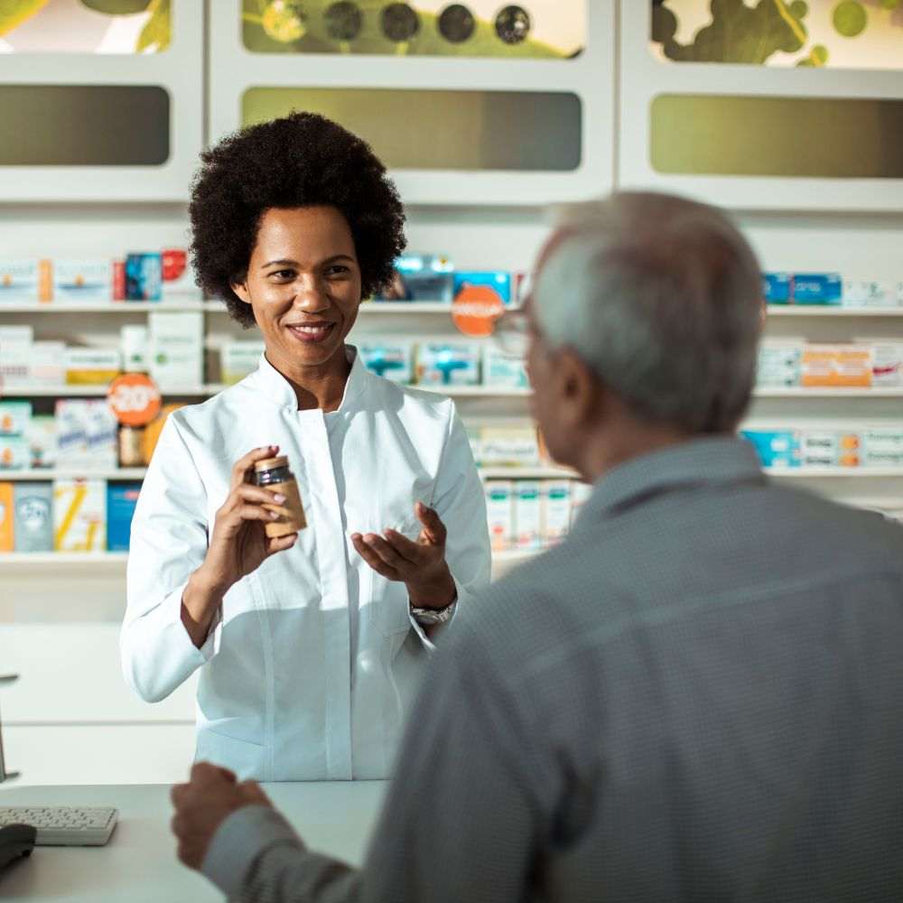 A person holding a bottle of prescription medication, highlighting the risks of drug-induced liver injury.