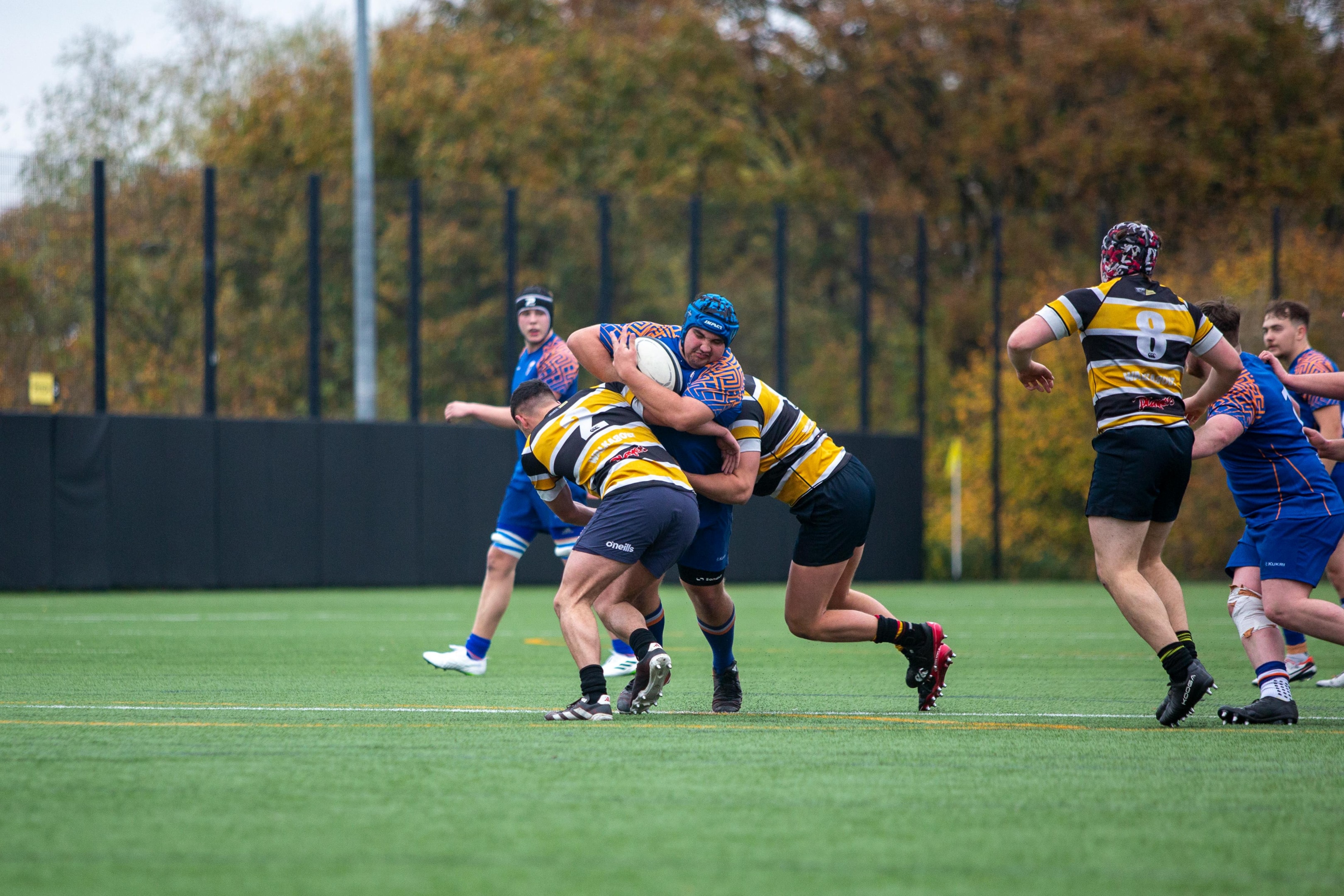 Only the ball carrier has the burden to be elusive, while everybody else has to go for the ball immediately. When dealing with one or more opponents in rugby, you have to be aware when the tackle occurs. These exercises can help you become an unstoppable defensive machine. You can get your tips on how to tackle properly from your coach, but developing the strength for a proper rugby tackle is another topic. Photo by Ollie Craig: https://www.pexels.com/photo/intense-rugby-match-on-green-field-29292729/