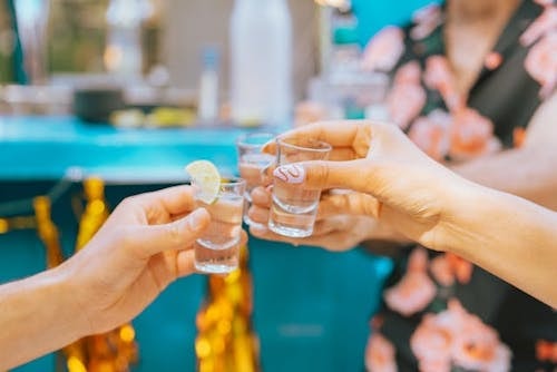 Women taking shots before they enjoy custom cuisine and outdoor dining