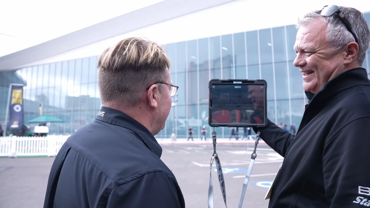 man showing ipad screen to other man