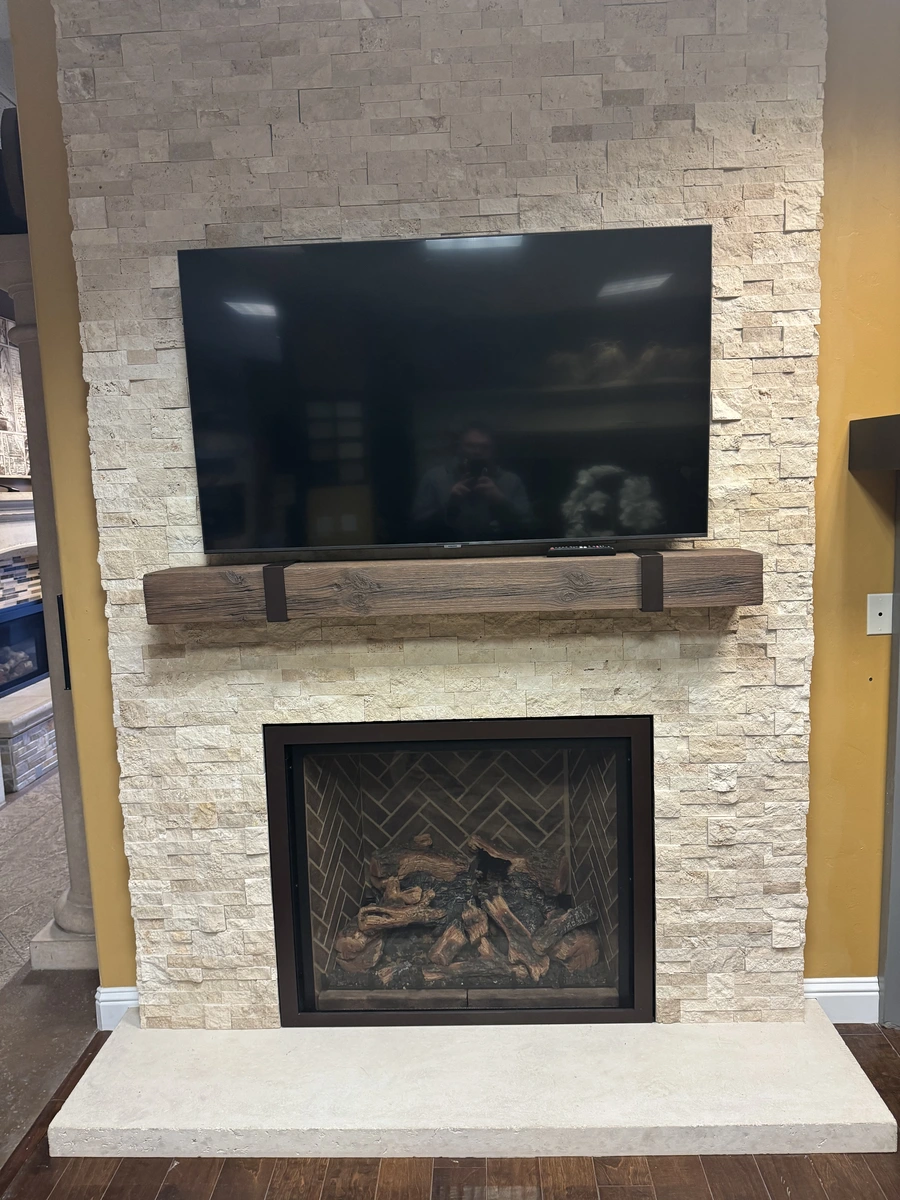 Large TV above the fireplace with MagraHearth Barnwood Mantel