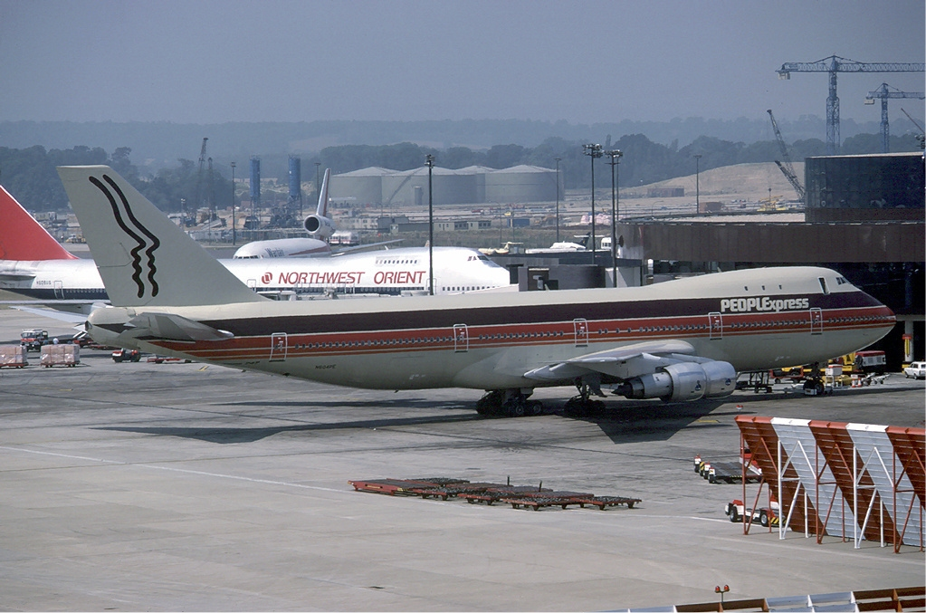 PeoplExpress airliner stationed at an airport.