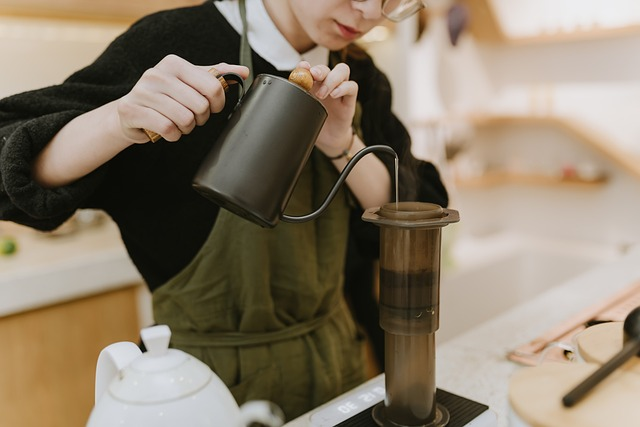 Barista preparing French press coffee 