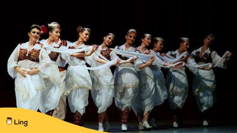 Group of women performing a traditional dance in vibrant Central Albanian folk costumes in Tirana, showcasing intricate embroidery and cultural heritage.