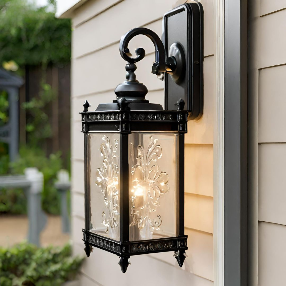 An exterior wall light inspired by French antique design aesthetics placed on an outside wall of a home.