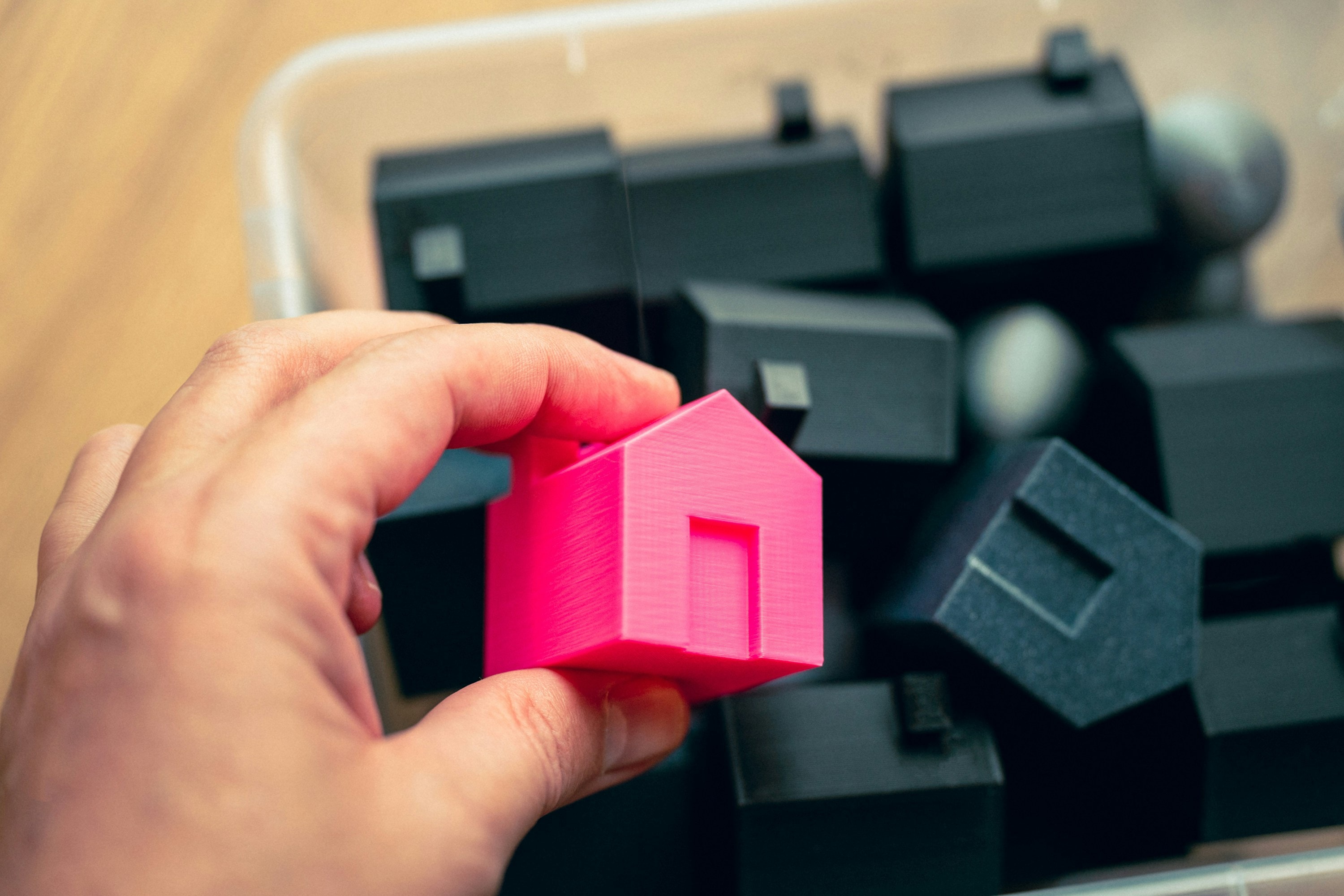 Real estate investor holds small mode of building that he will purchase as a rental property.