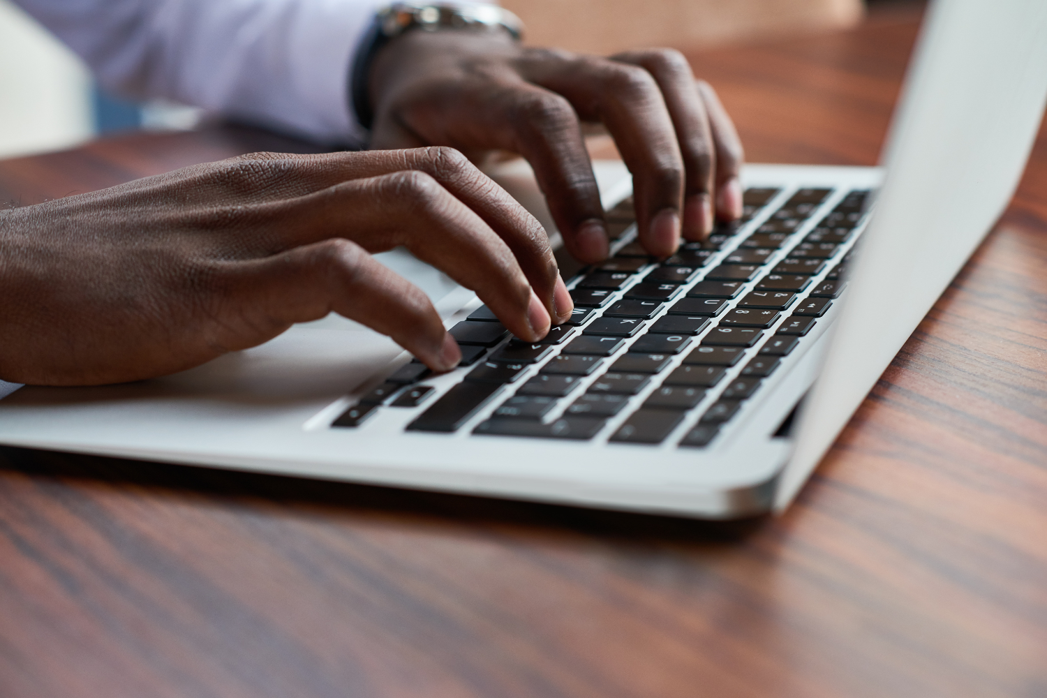 Hands on a keyboard, typing something.