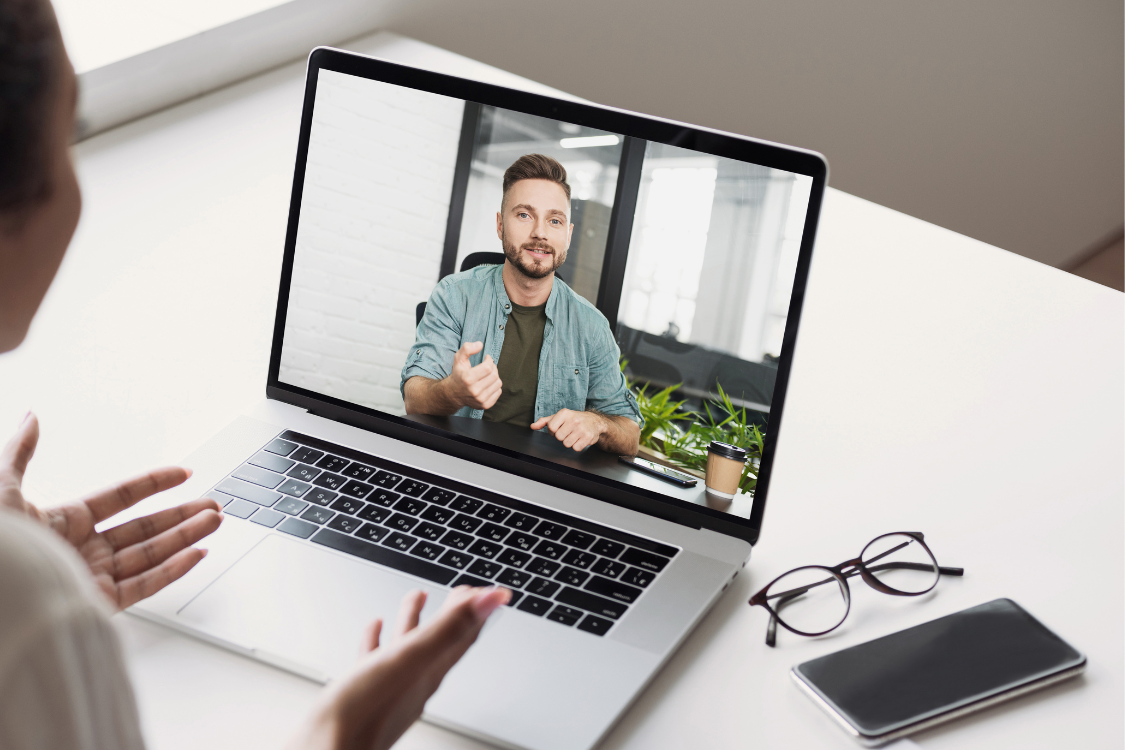 Filipino remote worker speaking to a manager on a video call during a coaching session