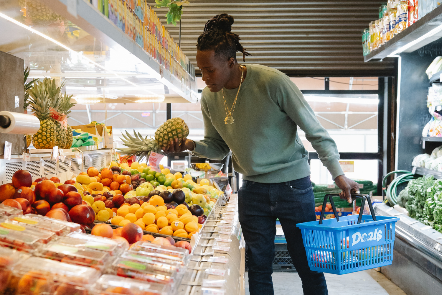 A shopper examining organic produce in a grocery store.