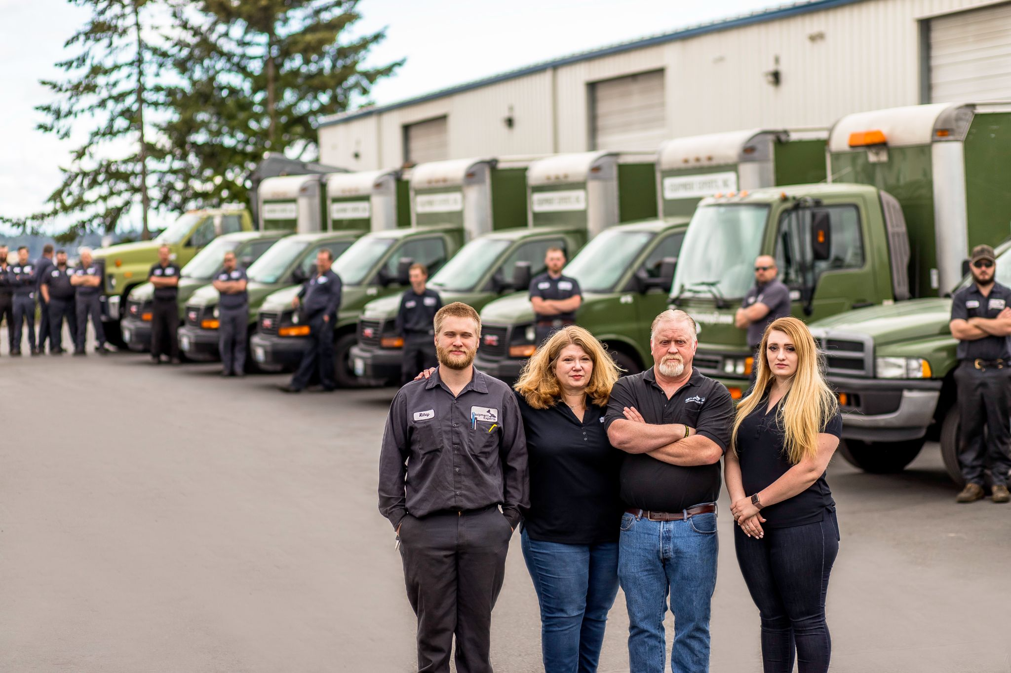 Equipment Experts, Inc. team in foreground and fleet in background