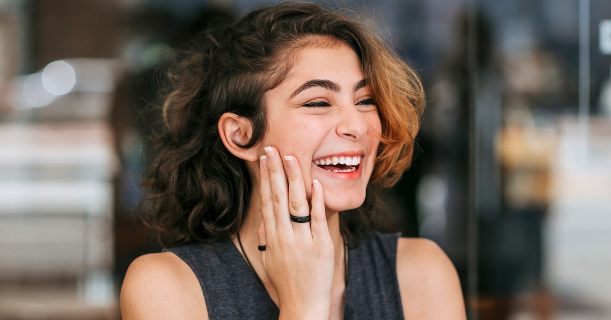 Happy woman laughing, feeling relieved after successfully completing a risk audit.