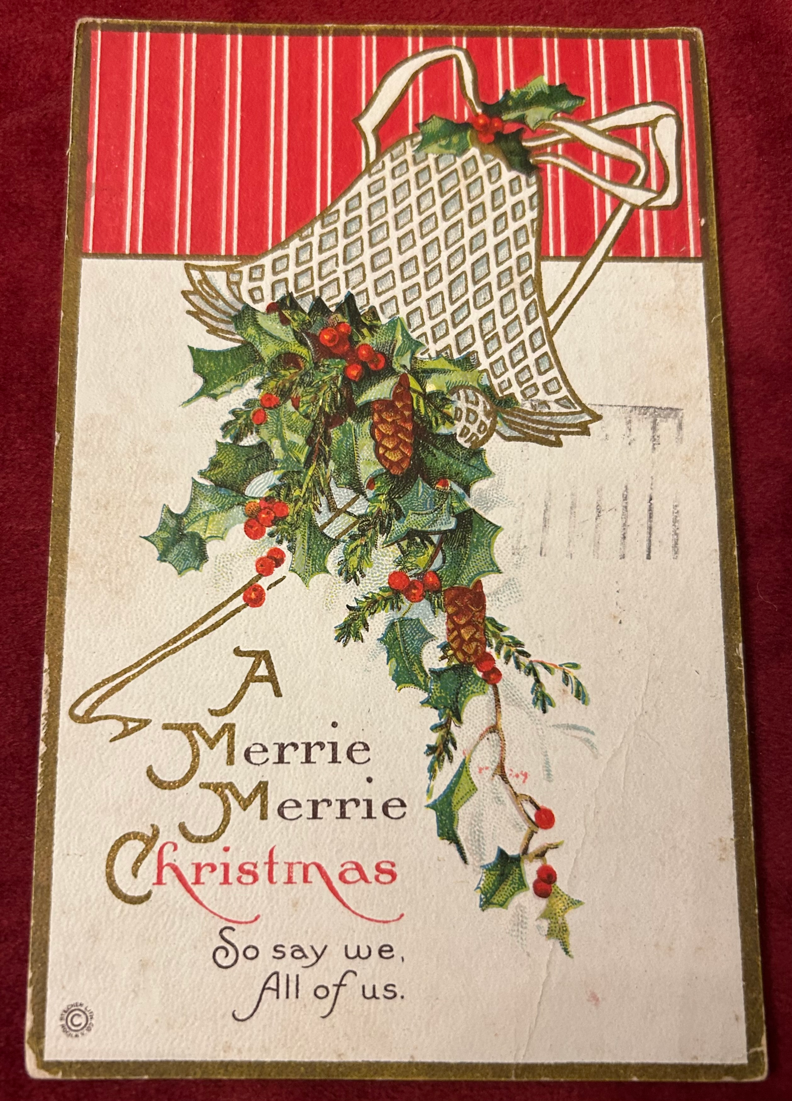 An antique Christmas postcard featuring a bell