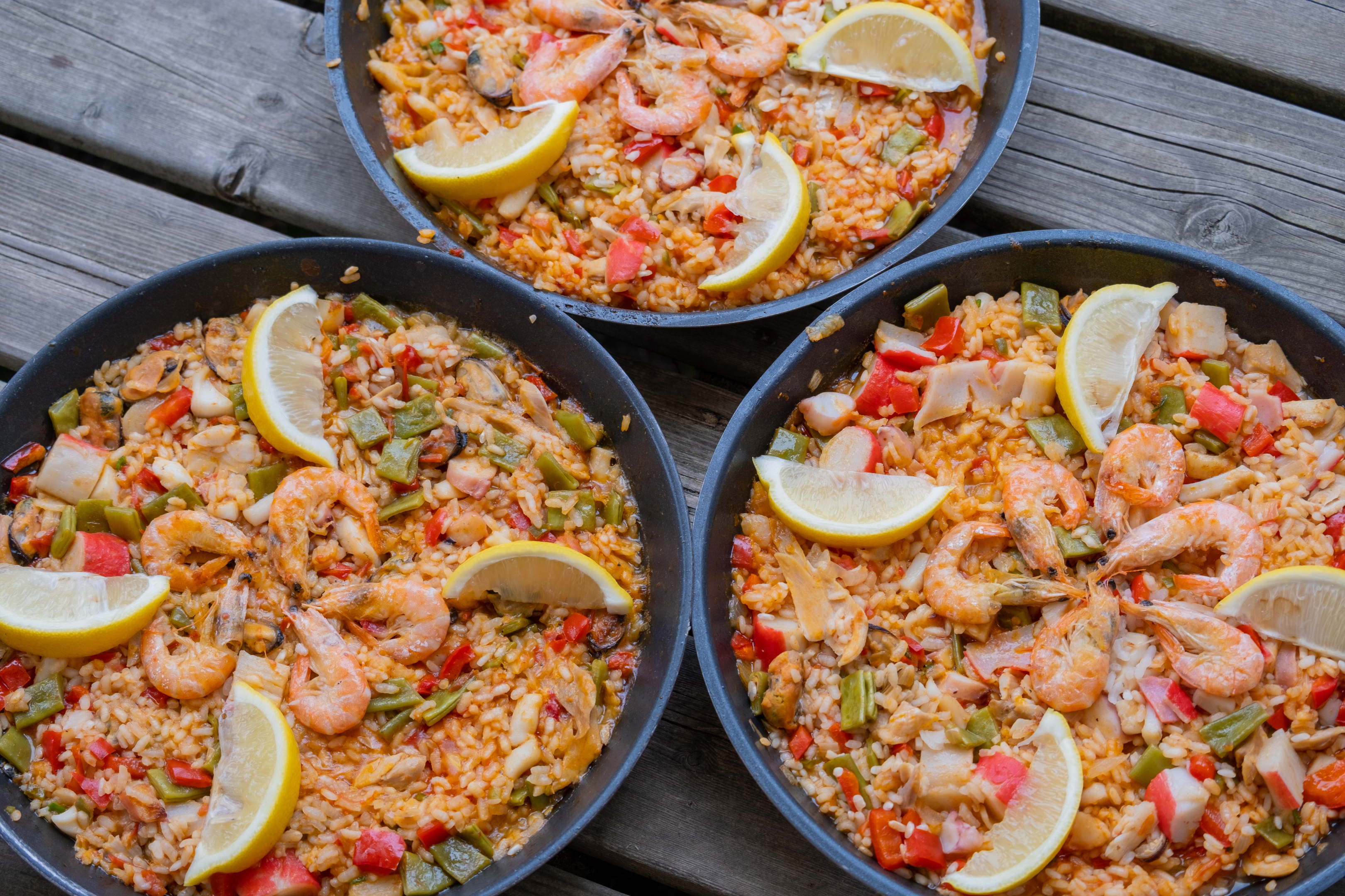 Image source: https://www.pexels.com/photo/3-plates-of-paella-the-food-of-the-spanish-kitchen-13207675/   Caption: 3 plates of paella